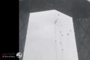 فيديو مخيف لعمال يتطايرون من اعلى مبنى شاهق في بكين